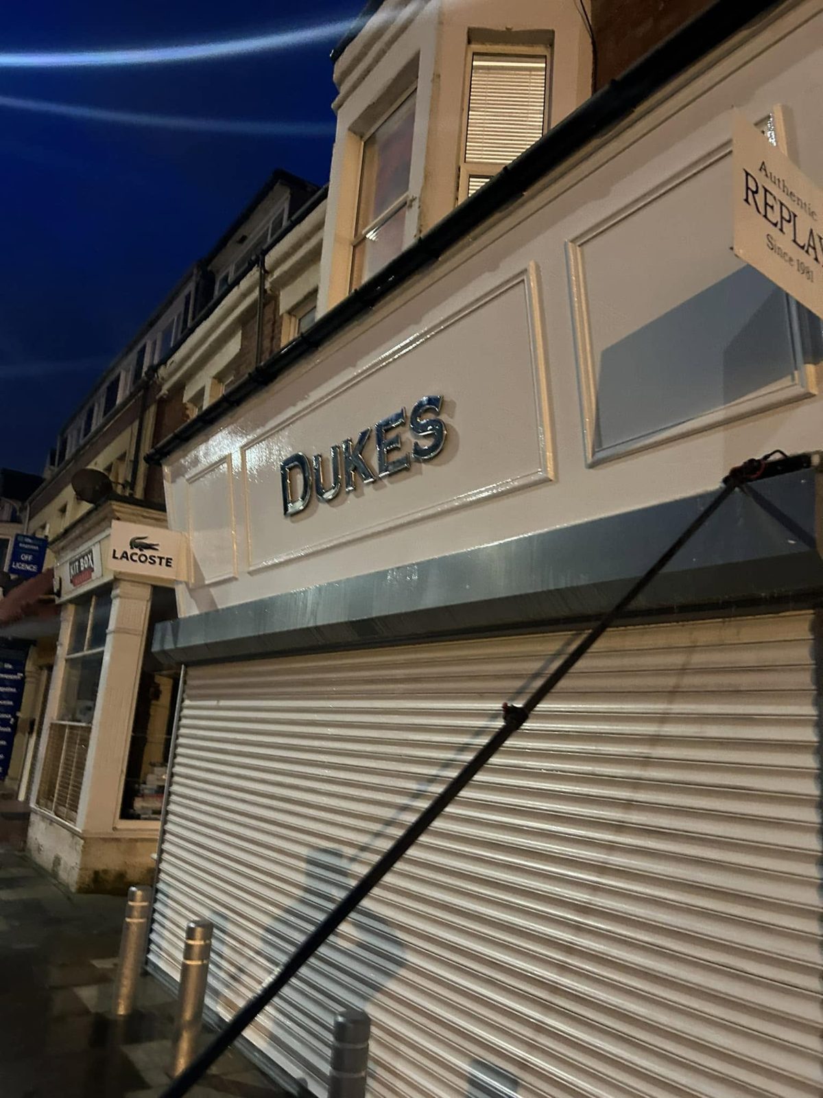 Water fed pole reaching the upper signage and windows above the Dukes shopfront