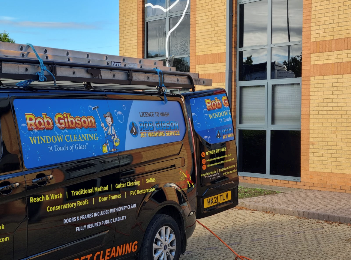 A Rob Gibson Window Cleaning van in full livery, reading A Touch of Glass and Est. 1969
